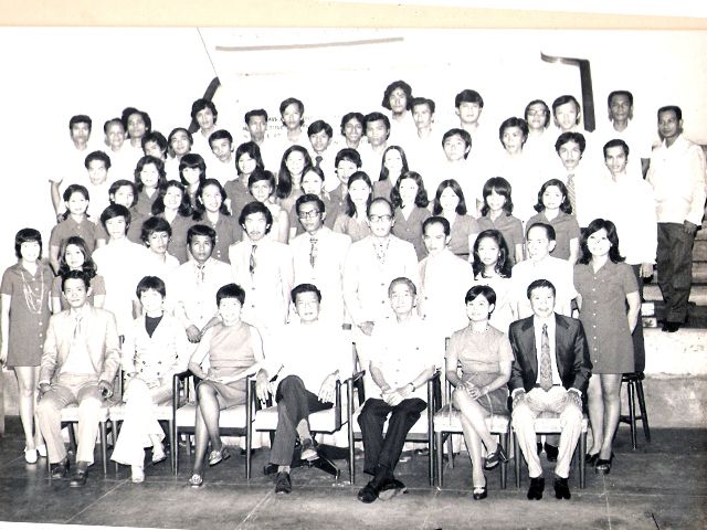 A large group of staff posed in rows for a company portrait